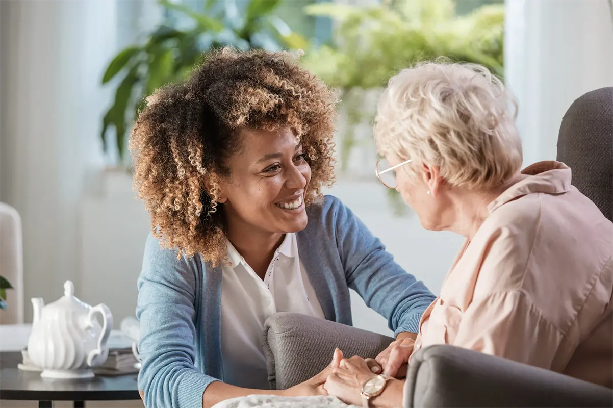 Nurse looking after elderly patient in care home